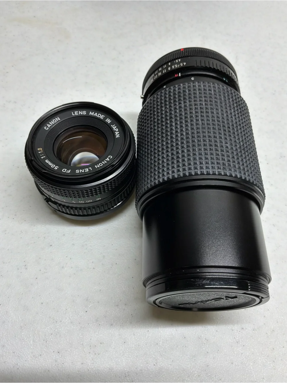 Canon T70 35mm SLR Camera with Black Telephoto Lens and Accessories
